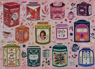 A completed puzzle of illustrated tea tins and tea cups on a pink background, each tin featuring unique colors, patterns, and designs.