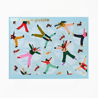 The Snow Much Fun 500 Piece Jigsaw Puzzle box features an illustration of people and dogs making snow angels on a light blue background during a snow day.