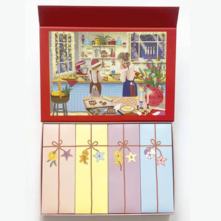 Discover the Sweet December Puzzle Advent Calendar by ViSSEVASSE—a festive box that opens to reveal five pastel-colored packages, each adorned with a unique charm, and an illustrated scene of two people baking in a holiday kitchen on the inside lid. This 1,000 piece jigsaw puzzle calendar is perfect for inspiring new holiday traditions or adding a magical Advent Calendar touch to your celebrations.