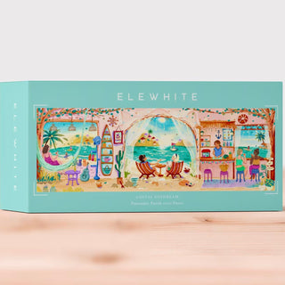 The Elewhite "Coastal Daydream" 1,000 piece jigsaw puzzle features original coastal artwork with beaches, palm trees, and cafés, all printed on premium board in a panoramic format.