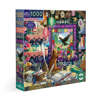 The Sorcerer's Workshop 1,000 Piece Jigsaw Puzzle by eeBoo features a vibrant, detailed wizard’s workshop scene with a cat, magical books, potions, and a window where a bird soars outside.
