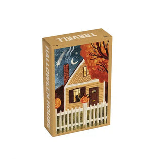 The Trevell Halloween House | 99 Piece Jigsaw Puzzle comes in a rectangular box decorated with artwork of a house adorned with pumpkins, a cat peeking out the window, and autumn trees beneath a night sky. Ideal for fans of trick-or-treating, this puzzle brings the festive spirit of Halloween to life in every detail.