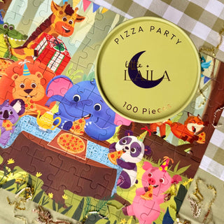 Pizza Party by Laila Luxury Puzzles is a 100-piece jigsaw puzzle featuring cartoon animals gathered around a table, with its round box lid partially covering the checkered surface. Made from recycled premium blueboard.