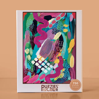 A Feel Your Feels | 750 Piece Jigsaw Puzzle box featuring an abstract, colorful painting with the words Feel Your Feels written on it.