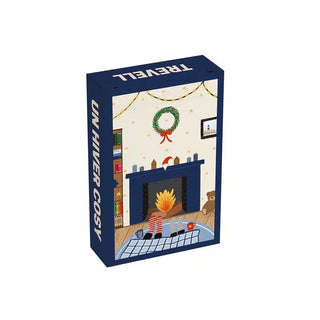 The Trevell Un Hiver Cosy | 99 Piece Jigsaw Puzzle comes in a box featuring an illustration of a cozy living room complete with a fireplace, wreath, holiday lights, gifts, teddy bear, and checkered rug with cups—ideal for anyone searching for a charming winter or Christmas puzzle to enjoy during the holiday season.