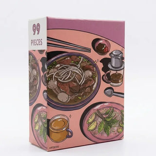 Arcadia Puzzles' Pho | 99 Piece Jigsaw Puzzle features illustrated pho bowls, herbs, tea, and condiments on a pink background. Sturdy pieces and a matte finish make assembly vibrant and satisfying.