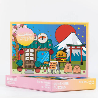 Enjoy assembling the Big in Japan 1,000 Piece Jigsaw Puzzle by Sunshine Puzzles, featuring Japanese-themed cartoon artwork with Mount Fuji, a torii gate, sushi, animals, and cherry blossoms.