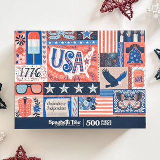 The Red, White & Blue | 500 Piece Jigsaw Puzzle by Spaghetti Tree features patriotic USA graphics inspired by 1776 and classic symbols—perfect for celebrating American history.