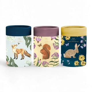 Discover the Forest Friends | Set of 3 100 Piece Jigsaw Puzzles from 1canoe2. This enchanting woodland animal puzzle set features three cylindrical containers, each adorned with painted animal illustrations—a fox on blue, a squirrel on purple, and a rabbit on yellow—beautifully decorated with flowers and leaves. Each container holds a delightful 100 piece mini jigsaw puzzle to enjoy.