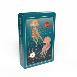 A teal box labeled "Deep Sea Dancers" by Penny Puzzle, with three illustrated jellyfish and a sea creature on the front, contains this charming 99-piece vintage minipuzzle.