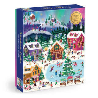 Immerse yourself in the enchanting Joy Laforme Northern Lights 1,000 Piece Jigsaw Puzzle from Chronicle Books, featuring a vibrant snowy village scene with skaters, festive homes, market stalls, pine trees, and the spectacular aurora borealis illuminating the night sky.