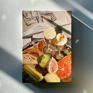 A still life of eggs, a pencil, notepad, crackers, green apple, grapefruit half, and orange slice on wood with shadows inspires the Breakfast | 500 Piece Jigsaw Puzzle by Das Puzzle Kollektiv—a plastic-free petit-déjeuner challenge.