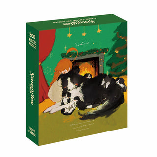 WEVE’s Snuggles is a 500 piece puzzle made from premium blue board, showing a person in red pajamas with a big black-and-white dog and puppies relaxing by a festive fireplace and Christmas tree.