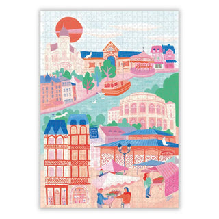Enjoy assembling Rennes, a 1,000 piece jigsaw puzzle by Aparté, featuring a vibrant town scene with colorful buildings, boats on a river, a bustling market, and a striking red sun in the sky.