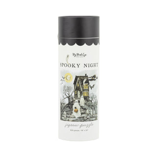 The Spooky Night | 500 Piece Jigsaw Puzzle by My Mind’s Eye comes in a cylindrical box featuring a haunted house, ghost, bare trees, full moon, and bats—ideal for spooky season fun!.