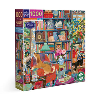 The eeBoo English Cottage Library 1,000 Piece Jigsaw Puzzle features Victoria Ball’s cozy, colorful library scene with books, armchairs, a dog, cat, flowers, and charming details—perfect for lovers of the English Cottage puzzle style.