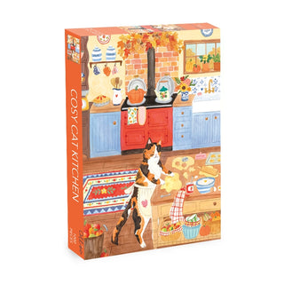 The Olleo Puzzles “Cosy Cat Kitchen” 1,000 piece jigsaw puzzle features charming artwork by Frankie Norman, depicting a cat baking in a vibrant kitchen with blue cabinets, a red stove, and autumn-themed decorations.