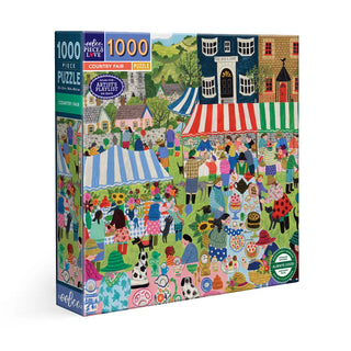 The eeBoo Country Fair 1,000 Piece Jigsaw Puzzle features a vibrant scene by Vanessa Bowman with people, tents, animals, flowers, and lively market stalls on a green field.