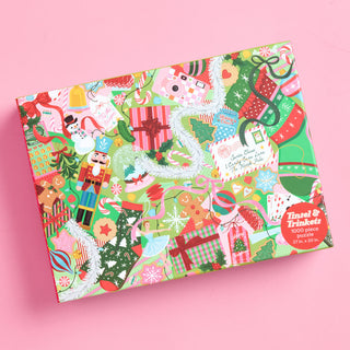 A Tinsel & Trinkets | 1,000 Piece Jigsaw Puzzle box featuring a festive Christmas pattern of presents, a snowman, a nutcracker, gingerbread cookies, and a letter to Santa on a light green background.