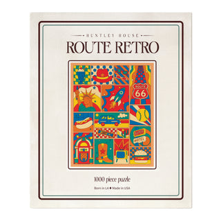 A Huntley House Route Retro 1,000 piece jigsaw puzzle featuring a colorful collage of Americana icons, including a Route 66 sign, a jukebox, a classic car, and a burger.