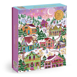 Experience the Galison Joy Laforme Snowcap Village 1,000 Piece Jigsaw Puzzle—featuring a vibrant winter village scene with snow-covered houses, skaters, pine trees, and a sparkling starry night.
