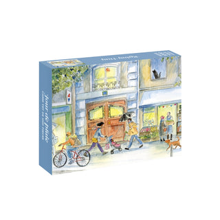 The WEVE Rainy Day 1,000 piece jigsaw puzzle box features a watercolor illustration of people walking and cycling on a city street during a rain shower.