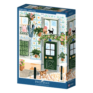 Portugal | 500 Piece Jigsaw Puzzle by Pieces & Peace features a charming Portuguese building with tiled walls, green doors, potted plants, a woman on the balcony, and two black cats. Proudly made in France.