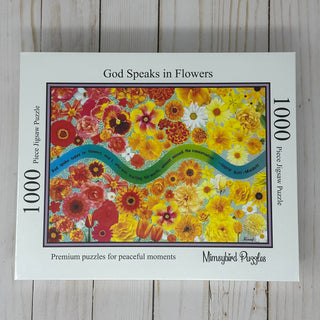 The God Speaks in Flowers | 1,000 Piece Jigsaw Puzzle by Mimsybird Puzzles features vibrant assorted blooms and a thoughtful quote displayed on a blue ribbon.