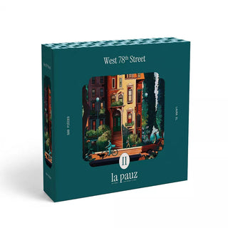 Box of West 78th Street | 500 Piece Jigsaw Puzzle by la pauz, an illustrated puzzle showcasing a charming city apartment scene with people and trees outside.