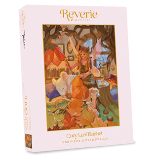 Cozy Leaf Blanket | 1,000 Piece Jigsaw Puzzle by Reverie Puzzles features whimsical maple leaf art with an autumn fairy, a large mouse, and cozy indoor autumn leaves.
