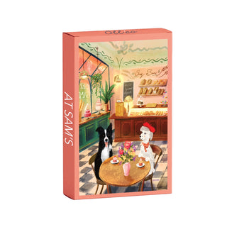 Charming illustration of two dogs enjoying treats at a café in front of a bakery counter. At Sam's | 99 Piece Jigsaw Puzzle by Olleo Puzzles—ideal for dog and bakery puzzle lovers.