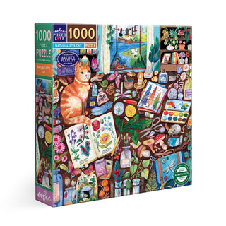 The eeBoo Naturalist's Cat 1,000 Piece Jigsaw Puzzle features a vibrant cat illustration with nature-themed art supplies and botanical drawings, made from recycled board—ideal for any naturalist puzzle lover.