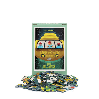 A 99-piece mini jigsaw puzzle box from Happily Jigsaw Puzzles, titled “The Life Acatic,” featuring artwork inspired by the iconic The Life Aquatic movie poster, with loose puzzle pieces displayed in front.