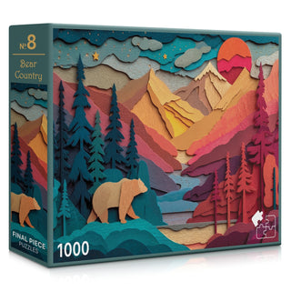 Bear Country | 1,000 Piece Jigsaw Puzzle by Final Piece Puzzles features an illustrated mountain landscape with a bear, vibrant trees, a river, and a sunset—perfect for adults wanting a scenic challenge.
