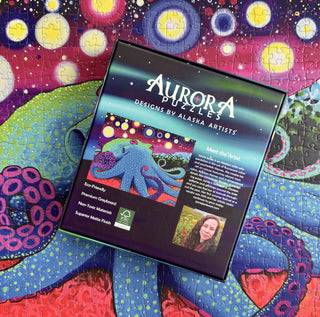 A completed Starry Octopus 1,000 piece jigsaw puzzle by Aurora Puzzles is displayed with its vibrant, colorful design and box featuring the brand logo and artist details—perfect for ocean enthusiasts.