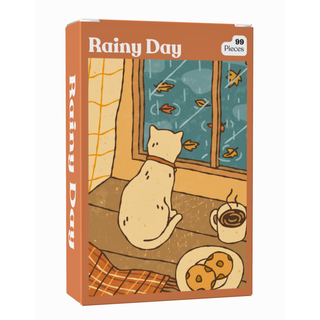 A Rainy Day | 99 Piece Jigsaw Puzzle pocket-sized box featuring a cat on a windowsill looking at rain, a mug of coffee, and a plate of cookies.