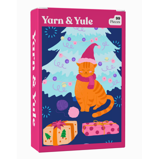 A Yarn & Yule 99 Piece Jigsaw Puzzle box featuring an orange cat wearing a Santa hat and scarf in front of a Christmas tree with gifts and yarn balls below.