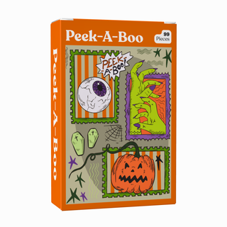 The Puzzledly Peek-A-Boo | 99 Piece Jigsaw Puzzle is a pocket-sized puzzle box featuring vibrant cartoon art—an eyeball, green hand, fangs, spiderweb, and pumpkin—all set against an orange background. This fun mini puzzle includes a matte finish for extra style and durability.