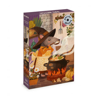 A Rat Witch 500 Piece Jigsaw Puzzle showing a mouse in a witch’s hat and apron, stirring a bubbling cauldron over a fire.