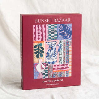 Puzzle Weekend’s Sunset Bazaar | 1,000 Piece Jigsaw Puzzle features a colorful, abstract Moroccan design with intricate travel-inspired patterns on the box front.