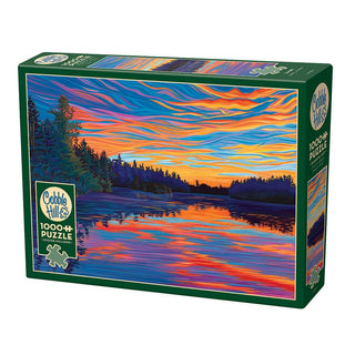 The Cobble Hill Sunset 1,000 Piece Jigsaw Puzzle features a colorful sunset illustration over a lake with reflected trees.