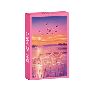 The Olleo Puzzles Dawn Chasers 99 piece jigsaw puzzle comes in a pink box featuring Camargue horses by a lakeside at sunrise with birds in the sky.