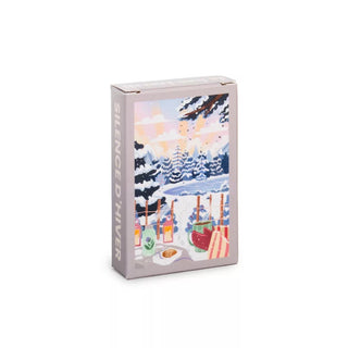 The Trevell Silence D'hiver 99 Piece Jigsaw Puzzle features illustrated winter scenery—snowy trees, two mugs, a teapot, and pastries—with "SILENCE D'HIVER" on the side; perfect for fans of winter-themed puzzles.