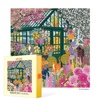 The WerkShoppe Spring Greenhouse | 1,000 Piece Jigsaw Puzzle features a vibrant greenhouse scene with blooming flowers, plants, cats, and birds; 1,000 piece puzzle box shown in the foreground.