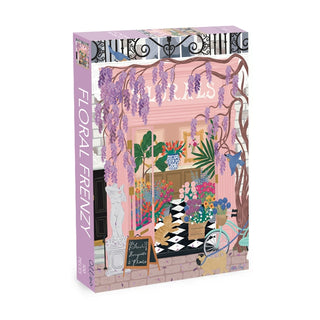 The Floral Frenzy 500 Piece Jigsaw Puzzle by Olleo Puzzles features a charming flower shop with pink walls, vibrant floral displays, a statue, bicycle, and chalkboard sign.