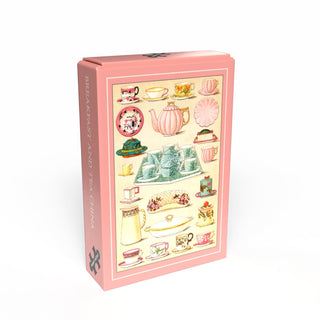 A pink rectangular box from Penny Puzzle, featuring vintage breakfast and tea china illustrations and "BREAKFAST TEA CHINA" on the side. Contains a charming 99 piece jigsaw puzzle for vintage lovers.