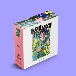 A 500-piece jigsaw puzzle box from Holiyay Puzzles, titled The Green House, featuring a colorful tropical leaf and plant design by Marie Boiseau on the cover, set against a vibrant purple background.