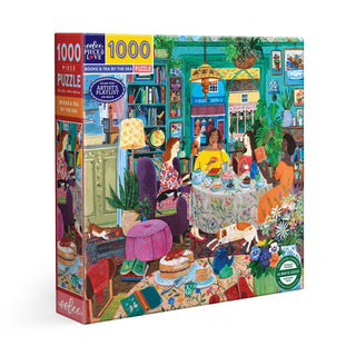 The eeBoo Books & Tea By the Sea 1,000 Piece Jigsaw Puzzle shows two women having tea in a vibrant, book-filled room with plants, art, and cats—ideal for a women’s reading group puzzle night.