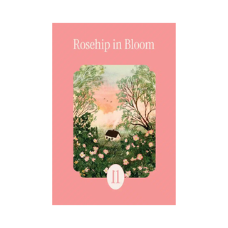 Rosehip in Bloom | 99 Piece Jigsaw Puzzle by la pauz features artwork by Laivi Põder, depicting a captivating scene of a small house nestled among blooming rose bushes and trees under a sunset sky. The pink card displays the number 11 at the bottom and beautifully showcases this enchanting mini puzzle.
