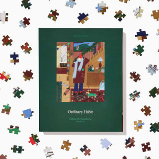The 500-piece jigsaw puzzle "Bundle Up" by Ordinary Habit is centered among scattered puzzle pieces on a white background.